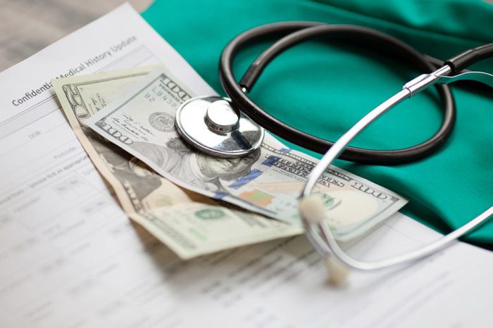 Dollars with stethoscope on them. Costs for the medical insurance.