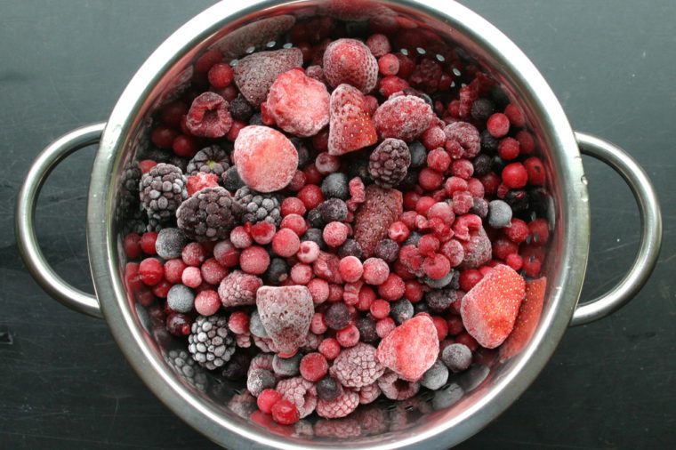Frozen berries in a metallic sieve