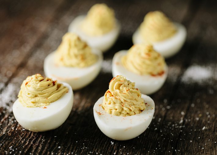 Homemade deviled eggs on wooden surface
