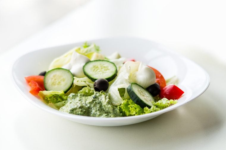 Greco salad with pesto sauce. Vegetable salad with Philadelphia cheese. Greek salad.