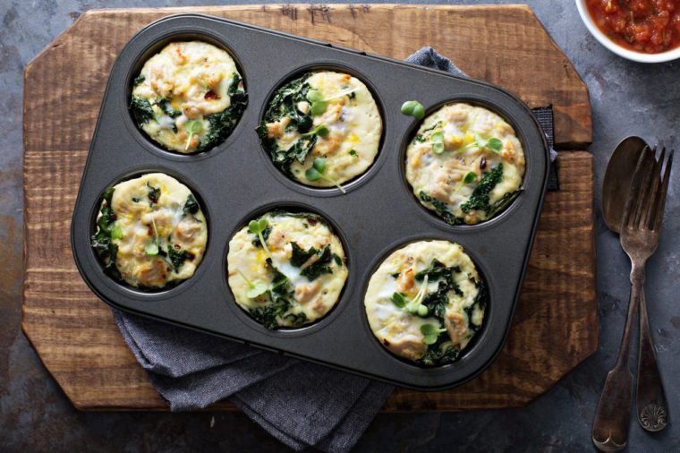 High protein egg muffins with kale and ground turkey in a muffin tin overhead shot