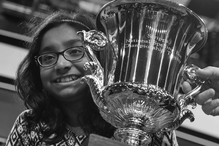 Ananya Vinay, 12, from Fresno, Calif., holds the trophy after being declared the winner of the 90th Scripps National Spelling Bee, in Oxon Hill, Md