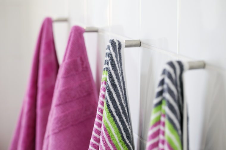 Clean new towels hanging in a bathroom.