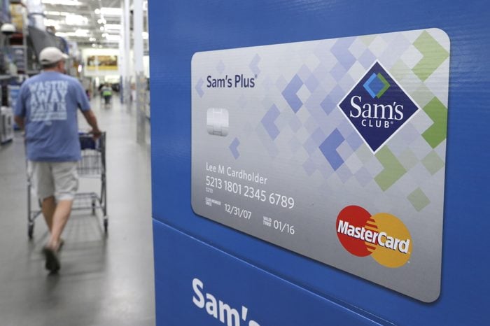A customer walks past a sign promoting Sam's Club MasterCard credit cards at a Sam's Club store store in Bentonville, Ark