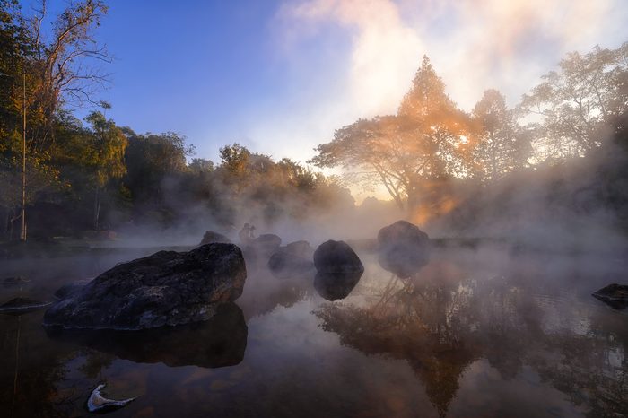The hot spring with a 73 degree Celsius water spring over rocky terrain. heat from the hot spring providing a misty and picturesque scene which is particular beautiful in the morning at National Park