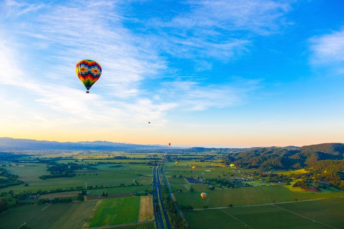 Hot Air Balloon Over Vineyards At Sunrise Over Napa Valley, Napa, California USA