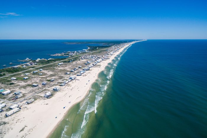 Drone/Aerial ocean photograph of the Gulf Shores/Fort Morgan peninsula. The warm Gulf of Mexico washes onto this pristine white sand beach. Alabama, USA 