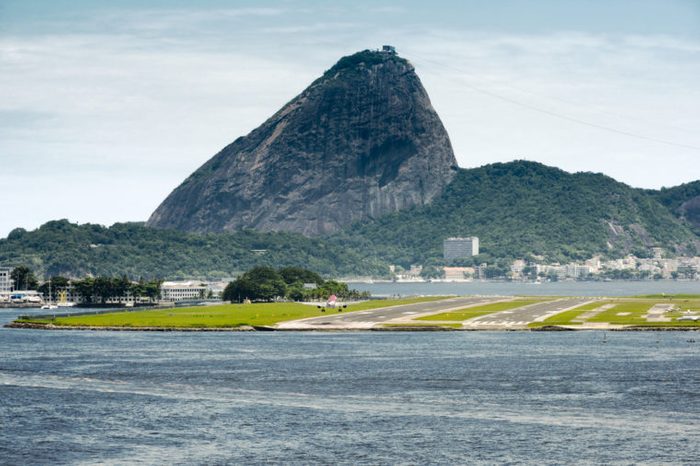 View Of A Passenger Airplane Landing At The Rio De Janeiro Airport With The City At The Background, Brazil