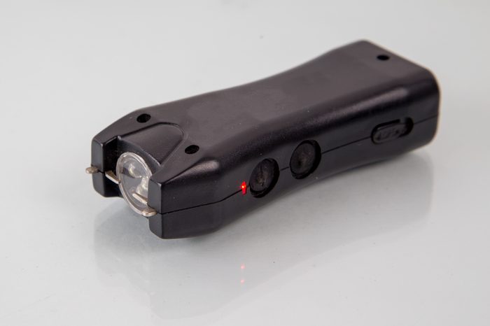 black plastic stun gun with flashlight , closeup