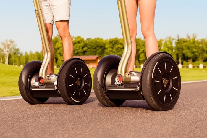 Close up photo of two people riding electric segways