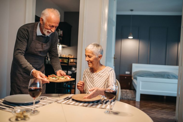 Elderly couple in the dining room about to enjoy their meal