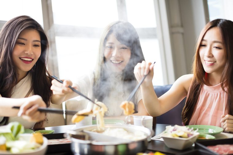 happy young Women group Eating hot pot 