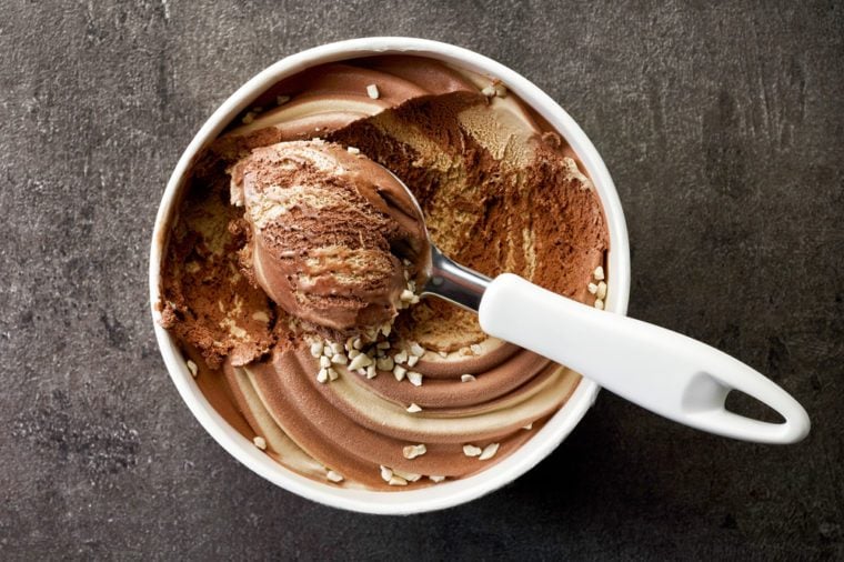 chocolate and peanut ice cream on dark gray table, top view