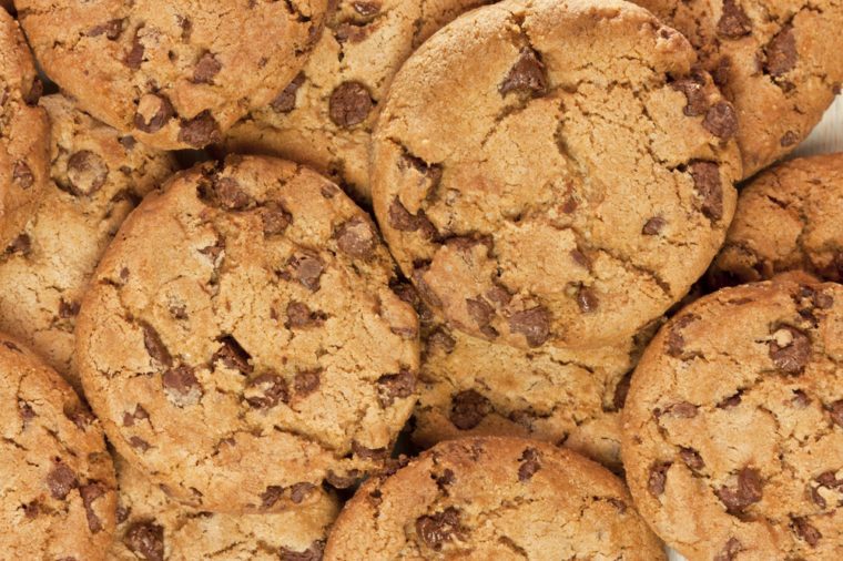A closeup of a pile of chocolate chips cookies, shot from above