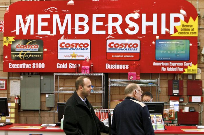 In a photo made, Consumers apply for Costco membership at the Costco Wholesale store in Glendale, Calif. Costco's fiscal third-quarter net income climbed 19 percent on lower asset charges and the wholesale club pulled in more money from membership fees