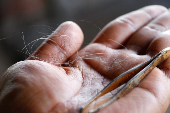Gray hair : The gray hair was pulled together on the palm : Close up of white hair and iron clamp hair on the palms of men.