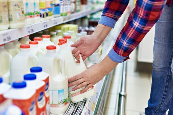 Woman shopping milk in grocery store