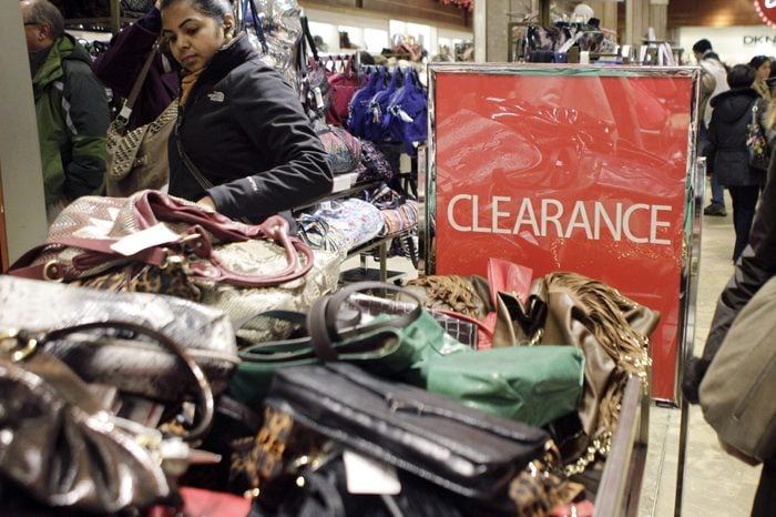 Shoppers browse through clearance handbags at Macy's flagship 34th Street store on the day after Christmas in New York, . Some retail stores, including Macy's offered even deeper discounts to shoppers who showed up between the hours of 8 a.m. and 12 noon on Monday
