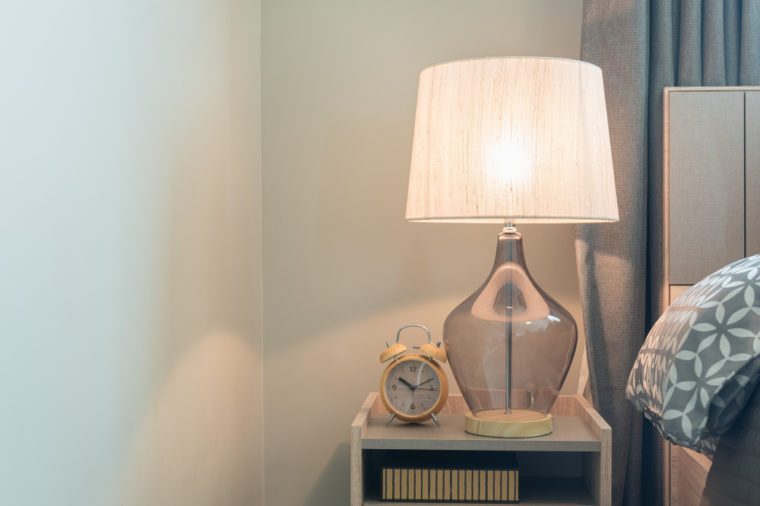classic lamp on wooden table side in modern bedroom, interior design concept