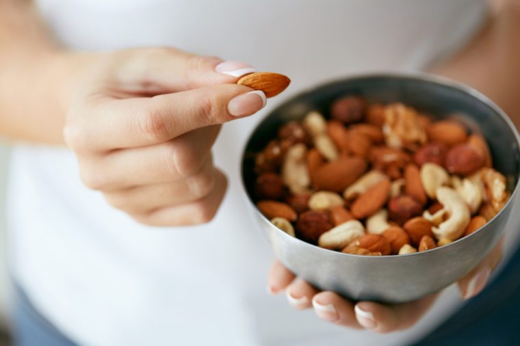 Healthy Food. Hands Holding Bowl With Nuts