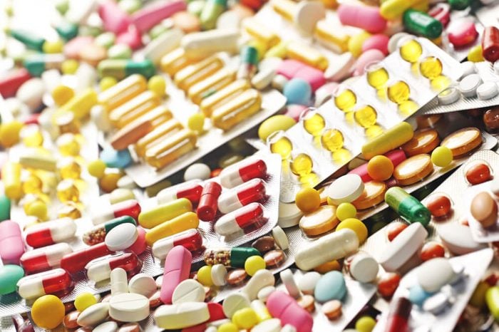 Pills close up and colorful blister packs