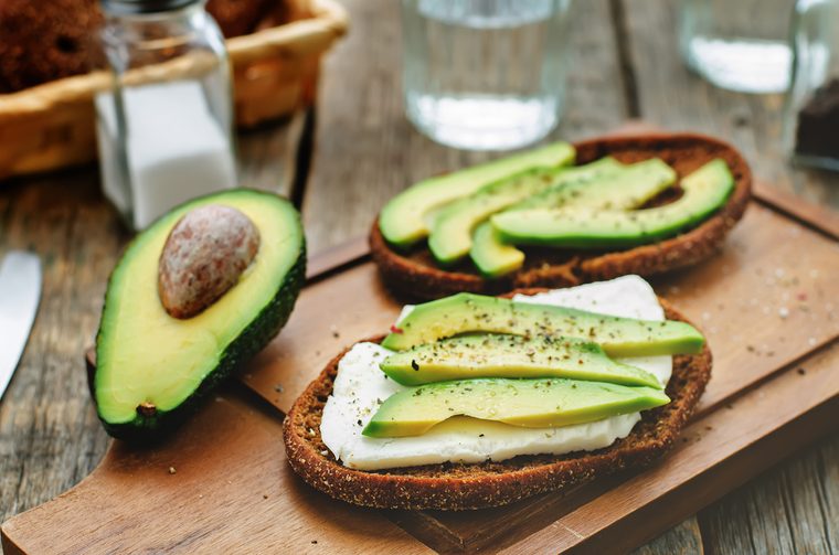 sandwich of rye bread with avocado and goat cheese. tinting. selective focus