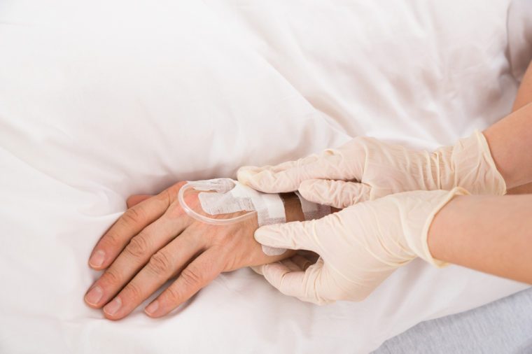 Close-up Of Doctor's Hand With Iv Drip Inserted In Patient's Hand