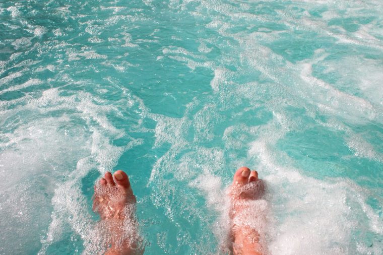 Dipping toes into warm bubbling hot tub