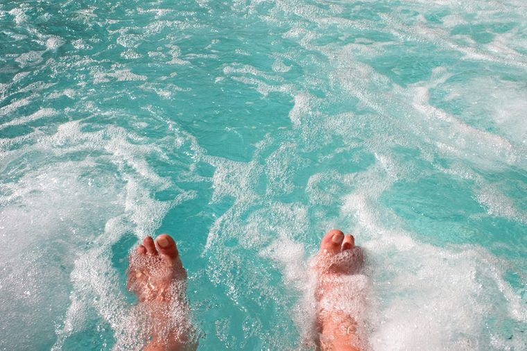 Dipping toes into warm bubbling hot tub