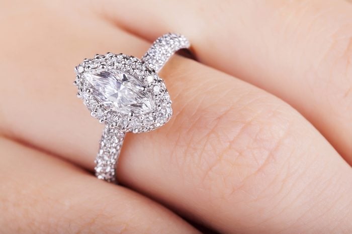Close up of elegant diamond ring. Close up of elegant diamond ring on the finger. Diamond ring.