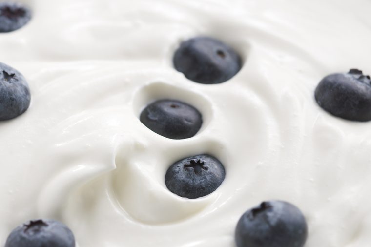 Blueberries in organic yogurt, 4k close up photo
