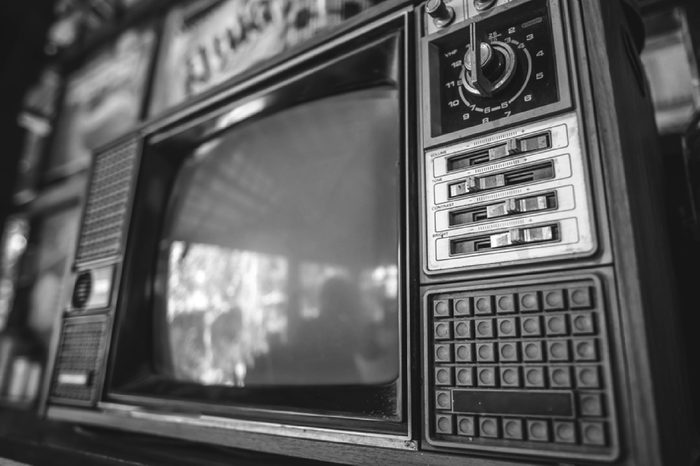 Antique grunge portable black and white television screen in vintage style.