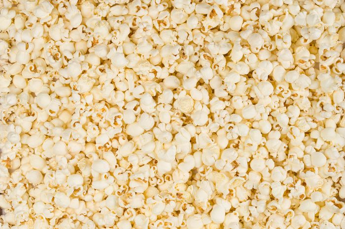 Scattered salted popcorn, texture background. 