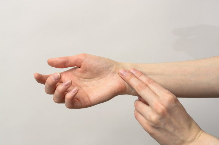 Medicine health care. Female hand checking pulse on wrist