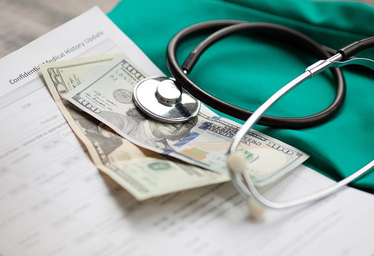 Dollars with stethoscope on them. Costs for the medical insurance.