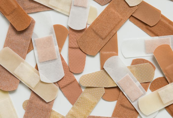 A collection adhesive bandages of various colors and shapes.