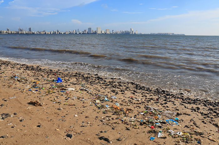 MUMBAI INDIA - NOVEMBER 12, 2017: Rubbish scattered in Chowpatty beach Mumbai.