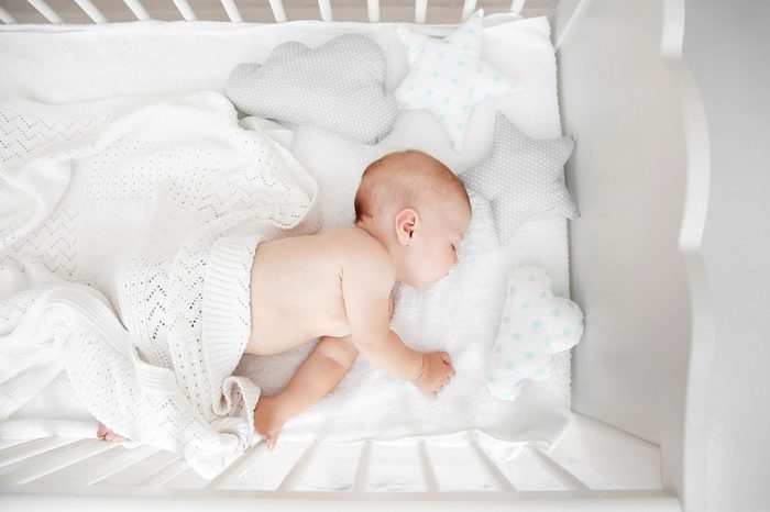 Little baby sleeping in crib , top view