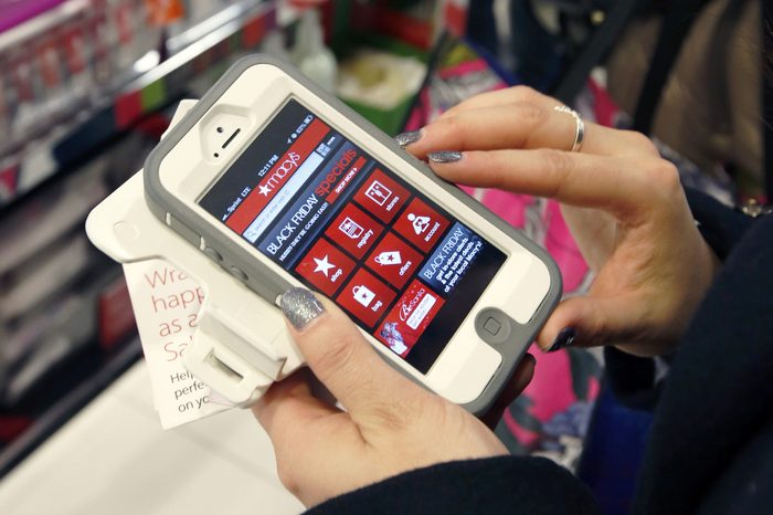 Tashalee Rodriguez, of Boston, uses her smartphone while shopping at Macy's in downtown Boston. Facebook isn't just for goofy pictures and silly chatter. Whether shoppers know it or not, their actions online help dictate what's in stores during this holiday season