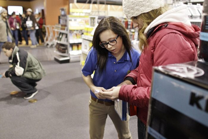 Best Buy electronics store employee Maddy Cooke, a criminology major in college, helps a customer looking to purchase an item, during a Black Friday sale that started at midnight, in Broomfield, Colo., early . Black Friday, the day when retailers traditionally turn a profit for the year, got a jump start this year as many stores opened just as families were finishing up Thanksgiving dinner