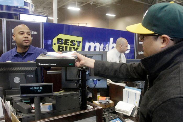 Mikel Calderon, right, buys a BlackBerry PlayBook tablet at a Best Buy store in San Francisco