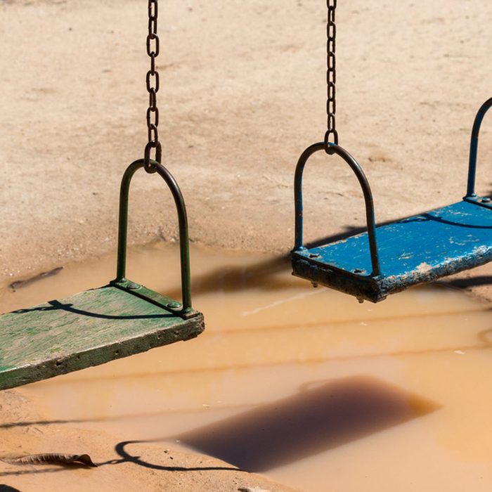 Swingset over a puddle on a playground