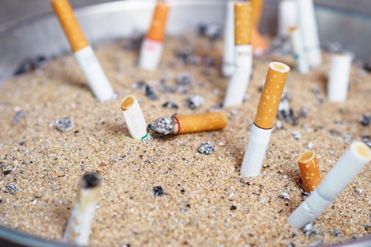 The rest of cigarettes in the ashtray. There are many types of cigarette stub on the sand in the ashtray. A cigarette is not good for health. It is not allow to smoking in the public area in Thailand.