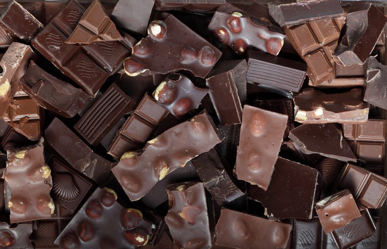Mix of chocolate bar pieces made of dark chocolate, milk chocolate / chocolate background