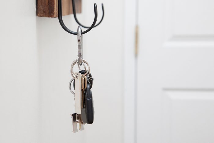 keys for home and car hang on a metal hook 