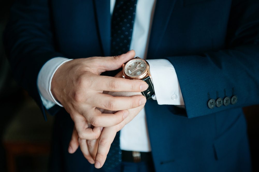 businessman looking at his watch on his hand, watching the time