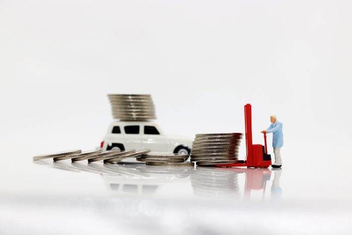 Miniature people: workers transport coins money with car, Concept of financial,retail,money saving and business.