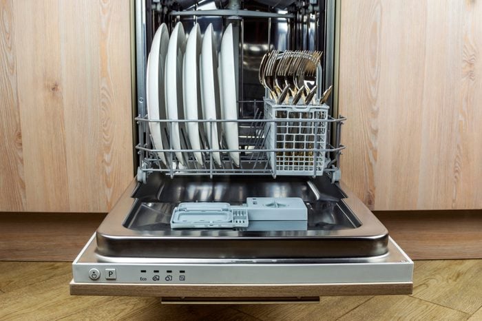 Dishwasher with clean cutlery and plates