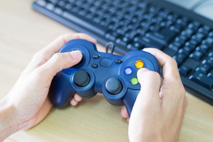 Hands man holds a joystick to play video game