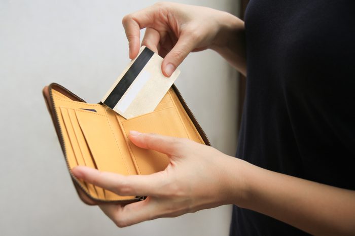 woman hand open leather wallet showing credit card